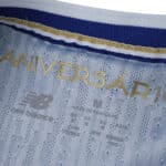 Close-up of the inner collar of the FC Porto 2025/26 Home Player Version shirt, showing gold anniversary text.