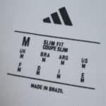 Size label of the Flamengo Away 2025/26 Fan Version jersey, showing medium size and slim fit, made in Brazil.