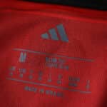 Close-up of Flamengo 2025/26 Home Fan jersey label showing adidas logo, size M, slim fit, and "Made in Brasil".