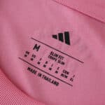 Close-up of the neck label on an Inter Miami CF Home 2025/26 Fan Version jersey, showing size and care info.