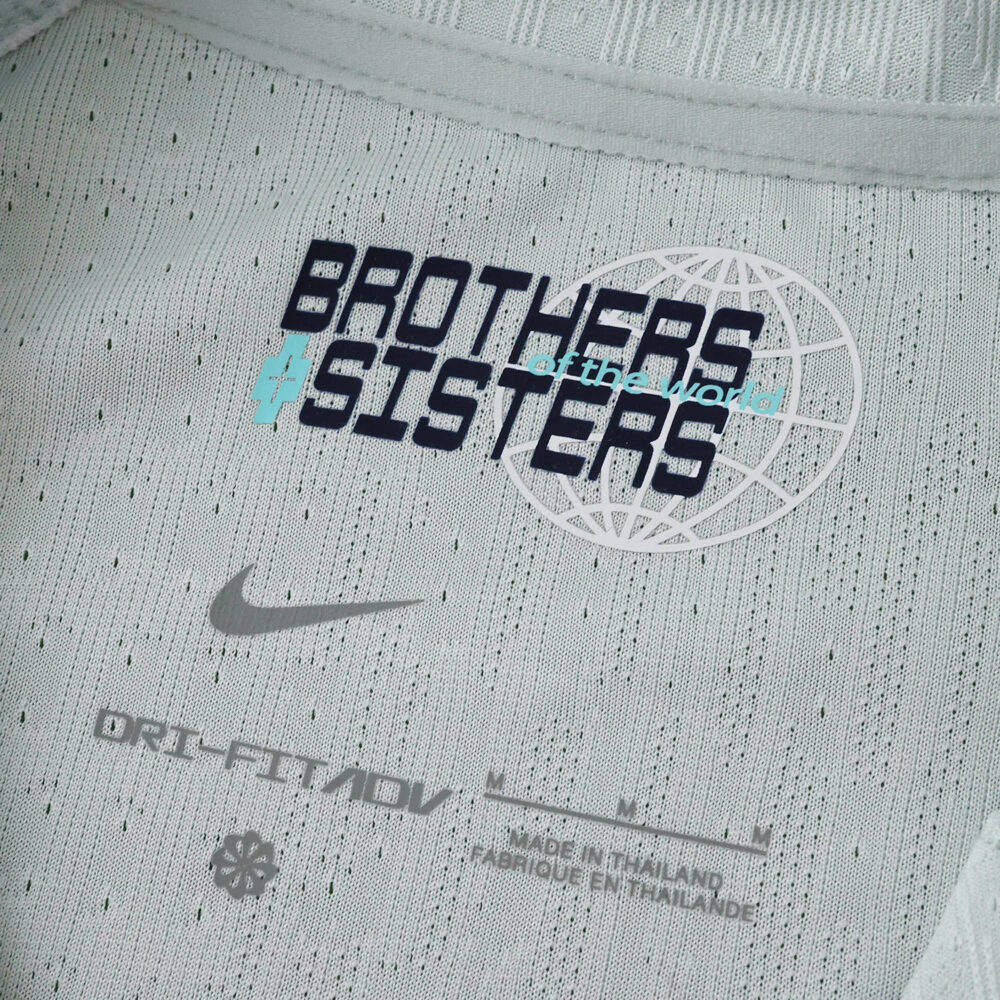 Close-up of Inter Milan Away 2025/26 Player Version jersey collar with "Brothers and Sisters" graphic.