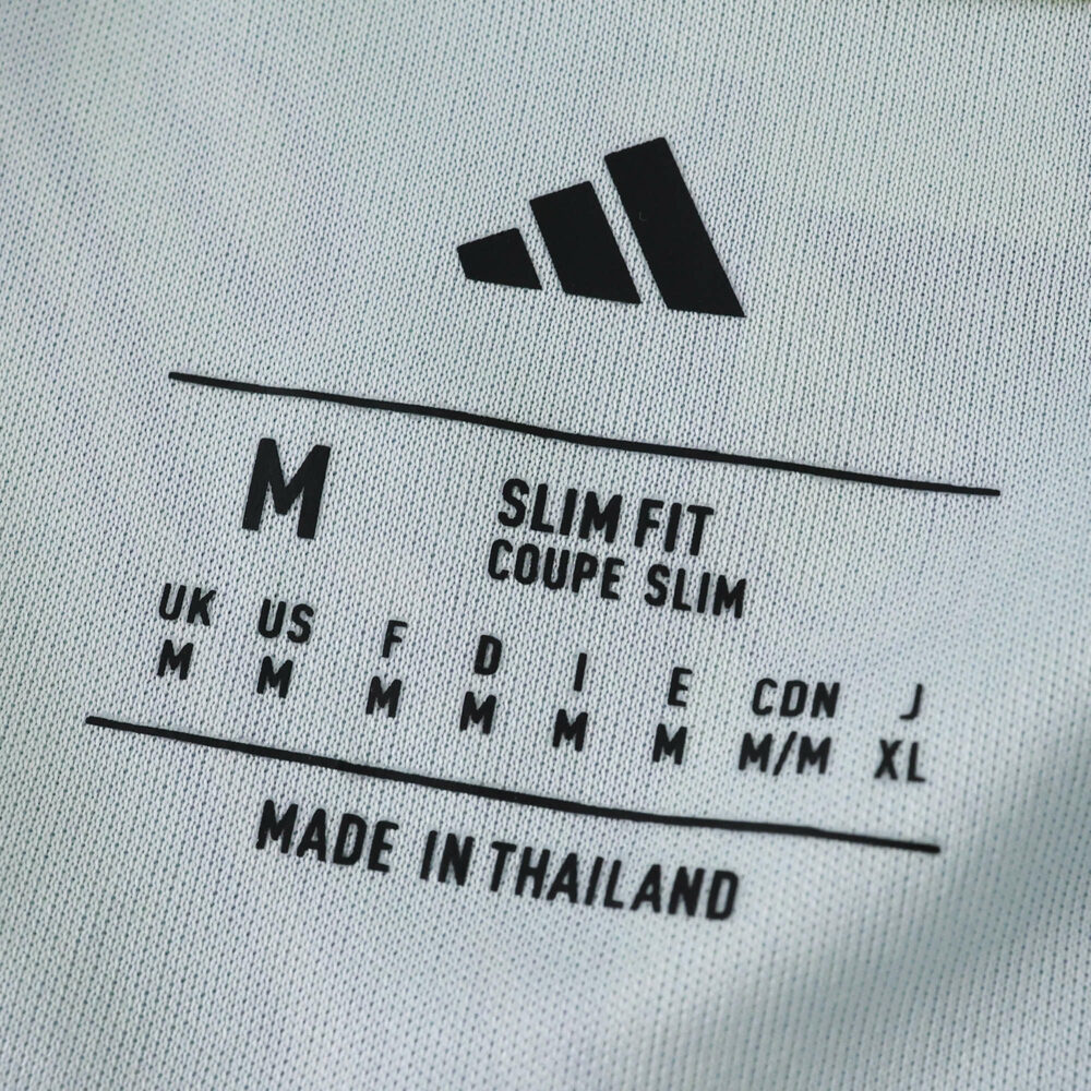 Juventus Away 2025/26 Fan Version shirt tag showing size M, slim fit, made in Thailand.