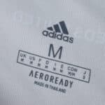 Leeds United 2025/26 Home Fan Version shirt tag showing Adidas logo, size M, and AEROREADY branding.