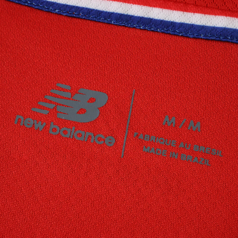 Close-up of Lille LOSC 2025/26 home jersey tag, showing New Balance logo and sizing details.