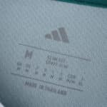 Close-up of Liverpool Third 2025/26 Fan Version jersey tag with Adidas logo, size details, and "Made in Thailand".