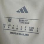 Size and fit label inside the New York Red Bulls Away 2025/26 Fan Version jersey, showing medium size.