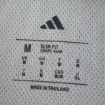 Neck label of the Newcastle United 2025/26 Player Version home shirt, showing size M and slim fit details.
