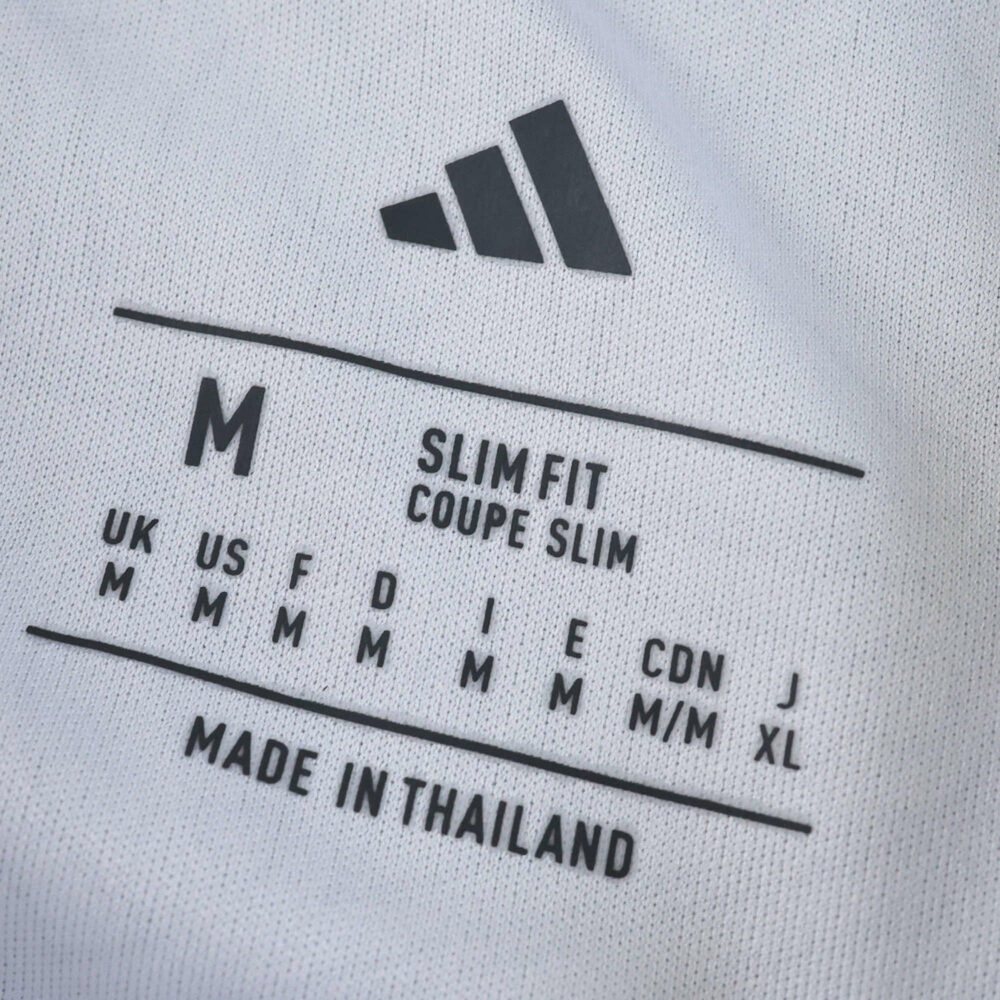 Close-up of Nottingham Forest Away 2025/26 Fan Version jersey label showing size M and slim fit details.
