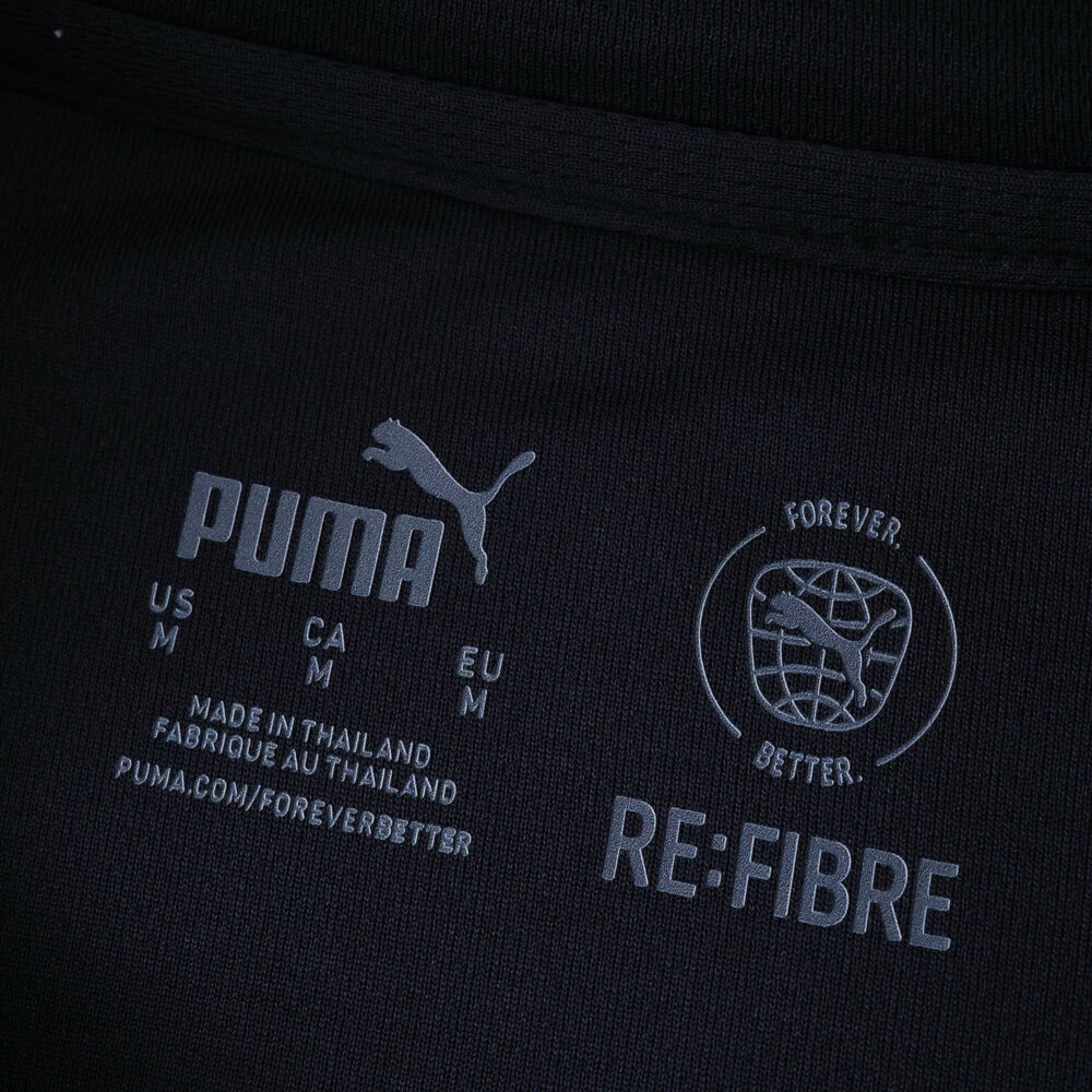Close-up of Olympique Marseille Away 2025/26 Fan Version inner label with Puma and RE:FIBRE logos.