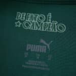 Detail of Palmeiras 2025/26 home jersey collar with "De Fato É Campeão" and Puma branding inside.