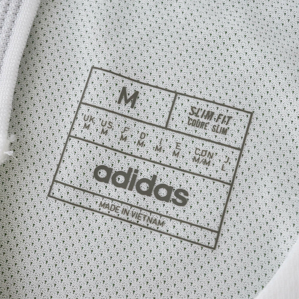 Close-up of adidas size label inside the Real Madrid 2025/26 Home Player Version jersey, showing size M.