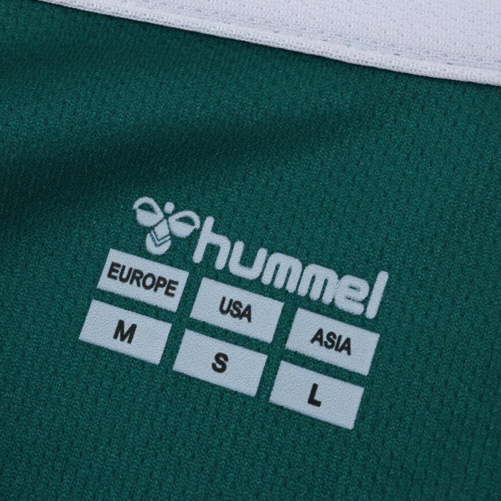Close-up of Werder Bremen 2025/26 home jersey showing Hummel logo and international size labels.