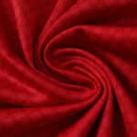 Close-up of the red fabric used in the Ajax Home 2025/26 Fan Version jersey, showing its texture and weave.