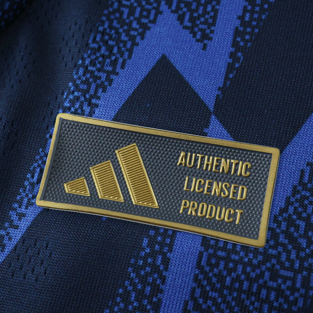 Close-up of the Authentic Licensed Product badge on the Arsenal Away 2025/26 Player Version jersey.