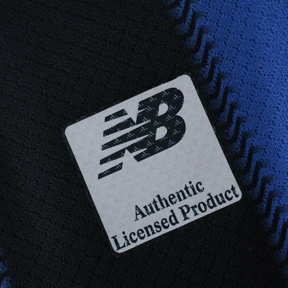 Close-up of New Balance Authentic Licensed Product tag on the Atalanta 2025/26 Home Fan Version jersey.