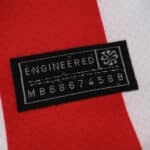 Close-up of the engineered patch on the 2025/26 Atlético Madrid home fan jersey, showing serial number.