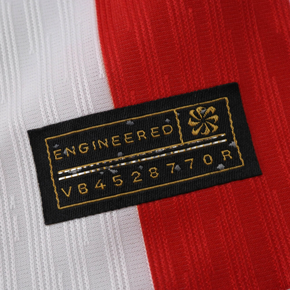 Close-up of Atlético Madrid 2025/26 Home Player Version jersey fabric and engineered authenticity tag.
