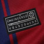 Close-up of the engineered label on the 2025/26 Barcelona Home Fan Version jersey fabric.