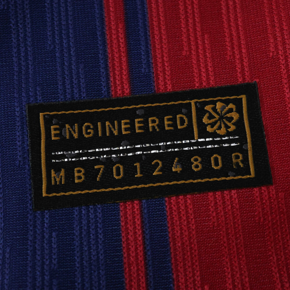 Close-up of the engineered authenticity patch on the 2025/26 Barcelona Home Player Version jersey.