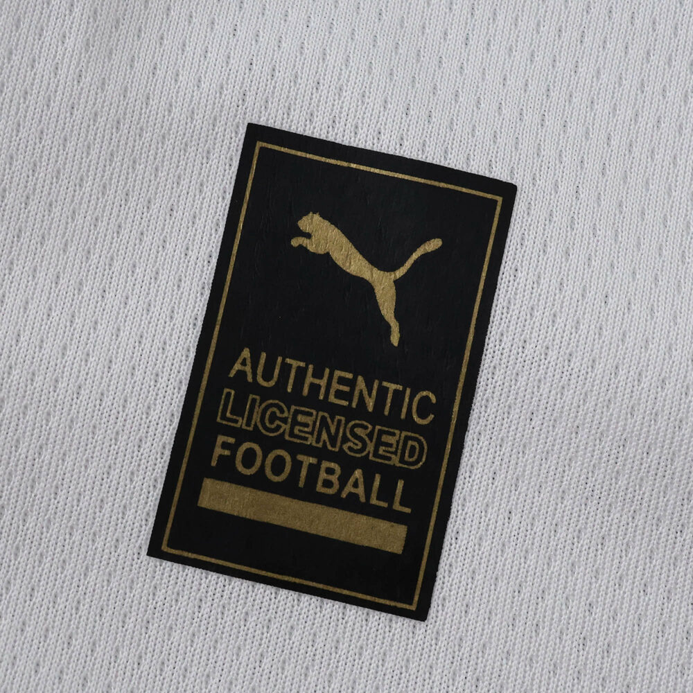 Close-up of the "Authentic Licensed Football" Puma patch on the Borussia Monchengladbach 2025/26 home fan jersey.