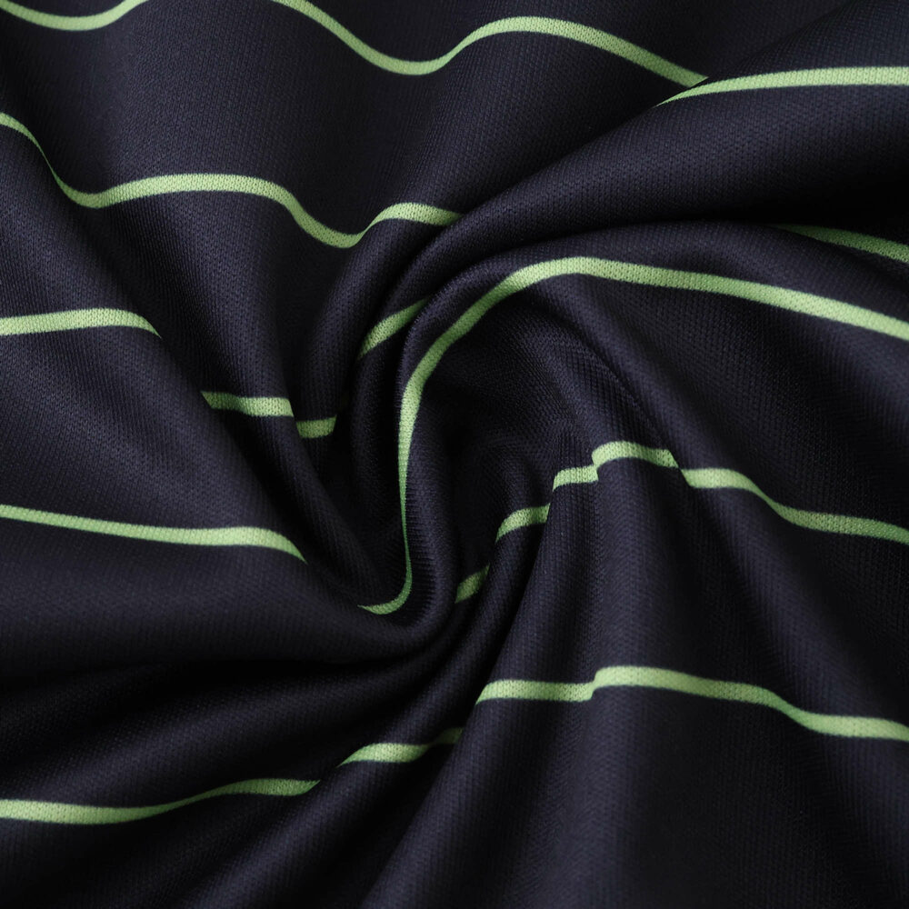 Close-up of Celtic Away 2025/26 Fan Version jersey fabric with green horizontal stripes on dark background.