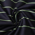 Close-up of Celtic Away 2025/26 Fan Version jersey fabric with green horizontal stripes on dark background.