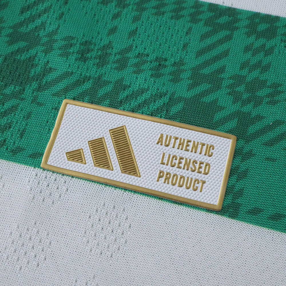 Close-up of the gold Adidas Authentic Licensed Product badge on the 2025/26 Celtic Home Player Version shirt.