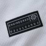 Close-up of the Corinthians 2025/26 Home Fan Version jersey's "Engineered" label on white fabric.