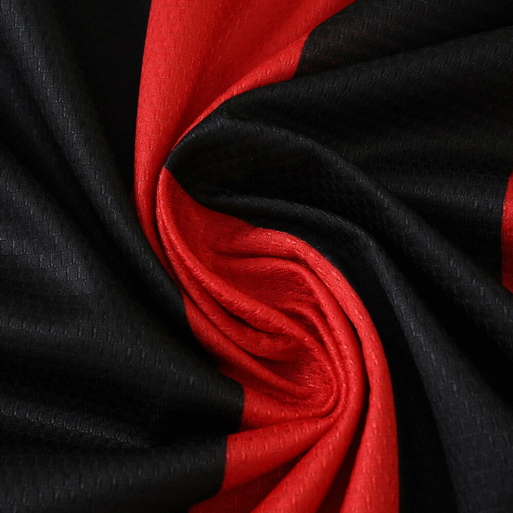Close-up of Eintracht Frankfurt 2025/26 home fan jersey fabric in red and black.