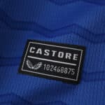 Close-up of the Castore logo patch on the 2025/26 Everton Home Fan Version jersey in blue fabric.