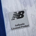 Close-up of New Balance Authentic Licensed Product badge on FC Porto 2025/26 Home Player Version jersey.
