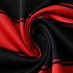 Close-up of Flamengo Home 2025/26 Fan Version jersey fabric showing red and black stripes.