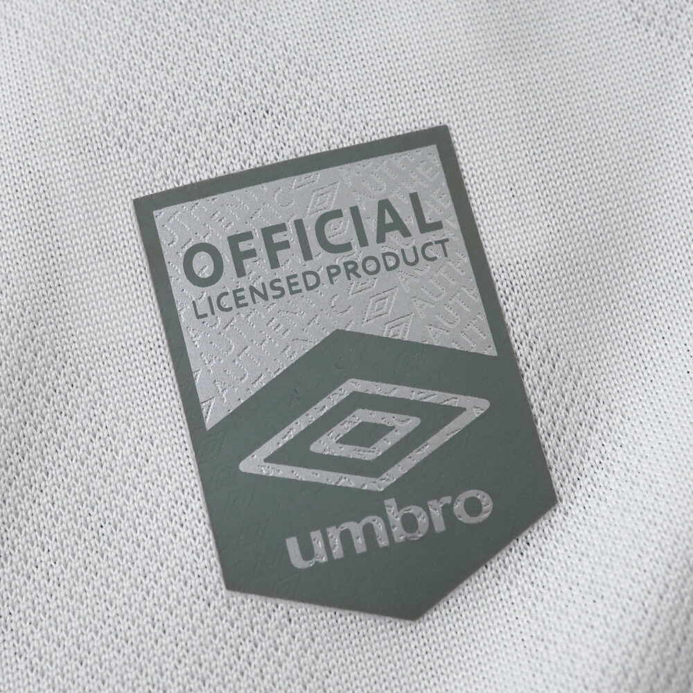 Close-up of the "Official Licensed Product" Umbro badge on the Fluminense Away 2025/26 Fan Version jersey.