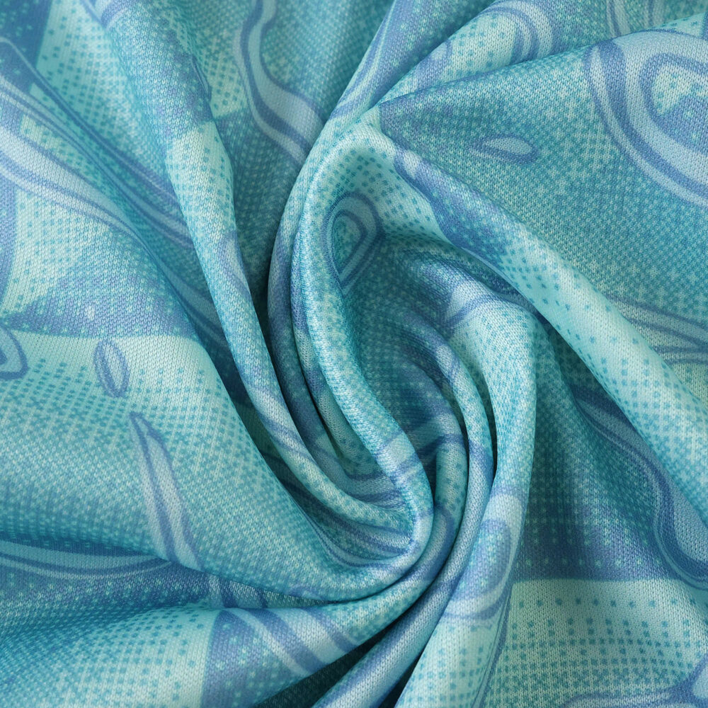 Close-up of blue and turquoise Juventus Away 2025/26 Fan Version jersey fabric with abstract patterns.