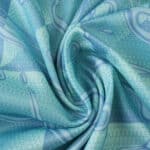 Close-up of blue and turquoise Juventus Away 2025/26 Fan Version jersey fabric with abstract patterns.