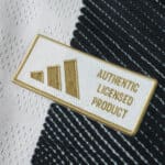 Close-up of the Authentic Licensed Product badge on the 2025/26 Juventus Home Player Version jersey.