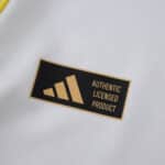 Close-up of the "Authentic Licensed Product" label on the Leeds United 2025/26 Home Fan Version jersey.