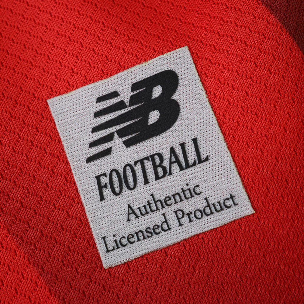 Close-up of the Lille LOSC 2025/26 Home Fan jersey featuring the New Balance Football authenticity label.