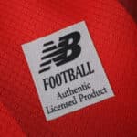 Close-up of the Lille LOSC 2025/26 Home Fan jersey featuring the New Balance Football authenticity label.