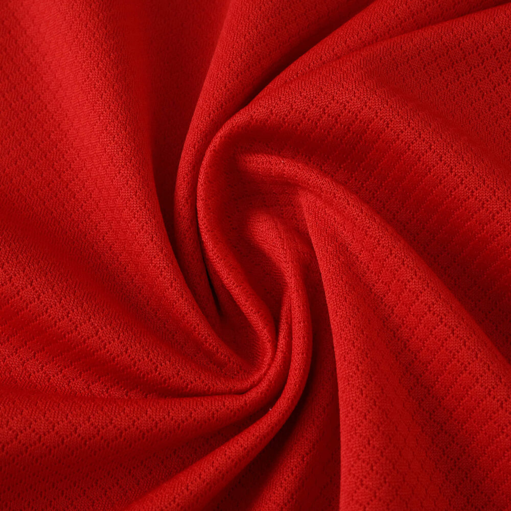 Close-up of red fabric texture for Liverpool Home 2025/26 Fan Version jersey, showing material detail.
