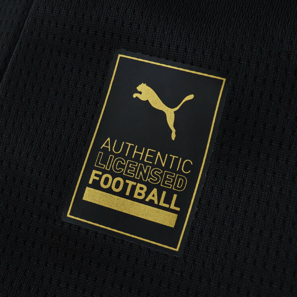 Close-up of the gold Puma Authentic Licensed Football patch on Manchester City Away 2025/26 Fan Version jersey.