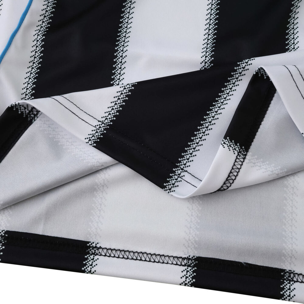 Close-up of Newcastle United 2025/26 home fan jersey fabric showing black and white stripes.