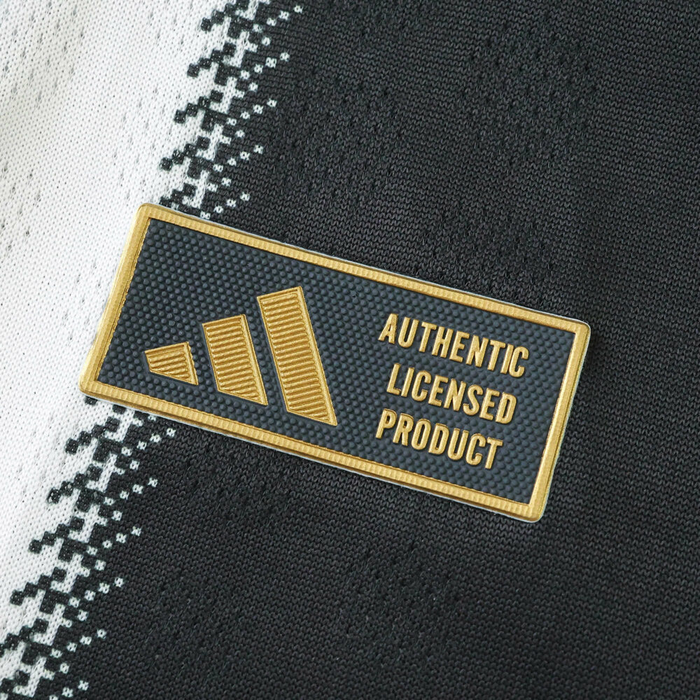 Close-up of the Authentic Licensed Product badge on the Newcastle United 2025/26 Home Player Version shirt.