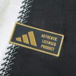 Close-up of the Authentic Licensed Product badge on the Newcastle United 2025/26 Home Player Version shirt.