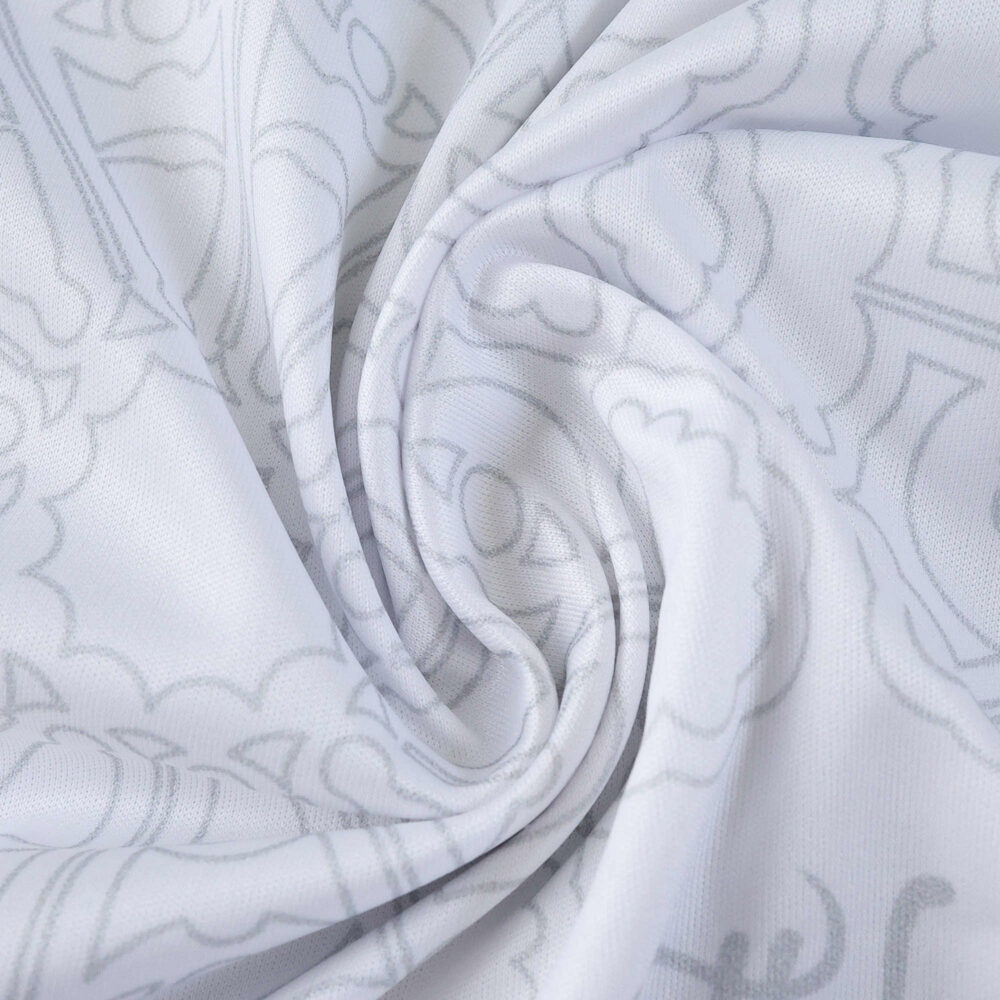 Close-up of Nottingham Forest Away 2025/26 fan jersey fabric, showing white material with subtle pattern.