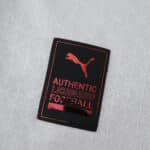 Close-up of the Puma authentic licensed football badge on the Olympique Marseille 2025/26 home player jersey.