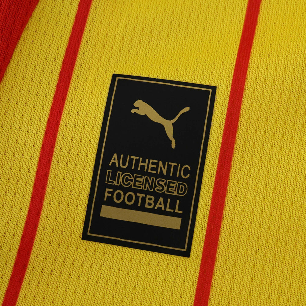 Close-up of the RC Lens 2025/26 home fan jersey showing Puma logo and authentic licensed football badge.