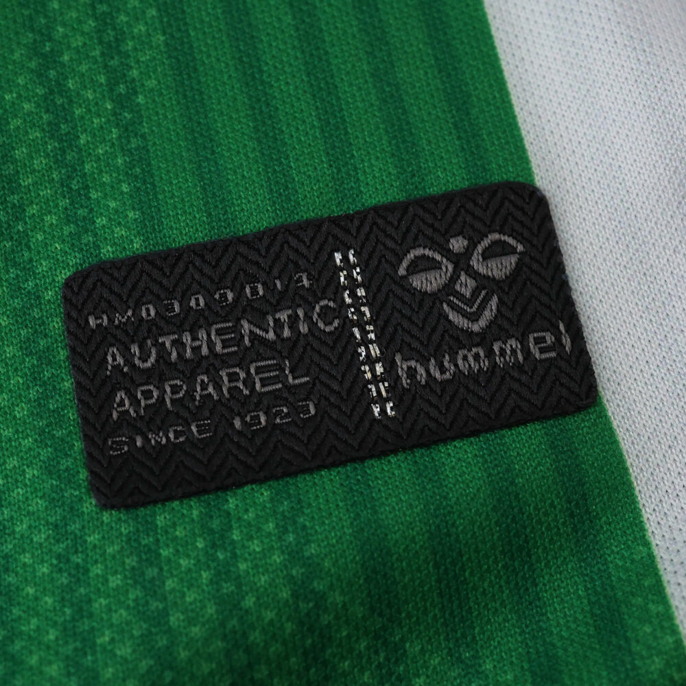 Close-up of the Hummel authenticity label on the 2025/26 Real Betis Home Fan Version jersey.