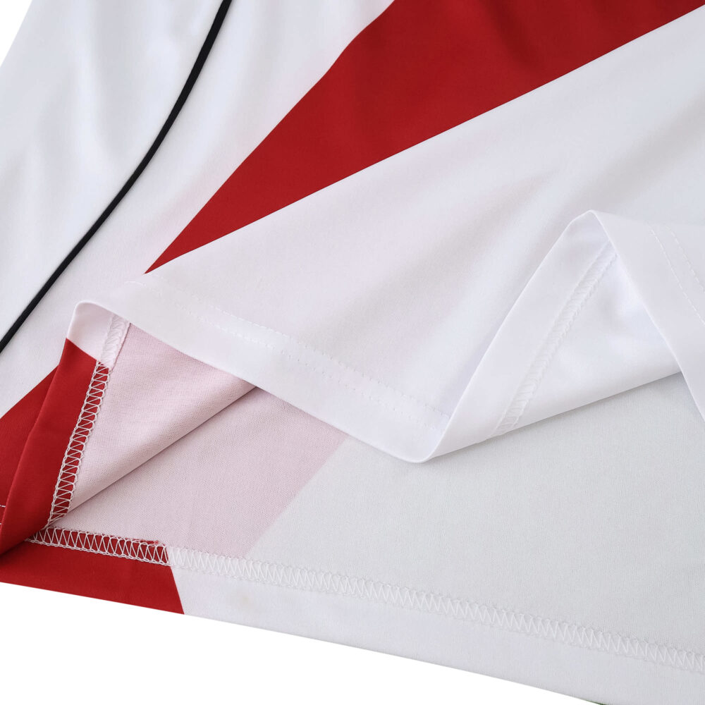 Close-up of the River Plate 2025/26 Home Fan Version jersey showing red sash detail and stitching.