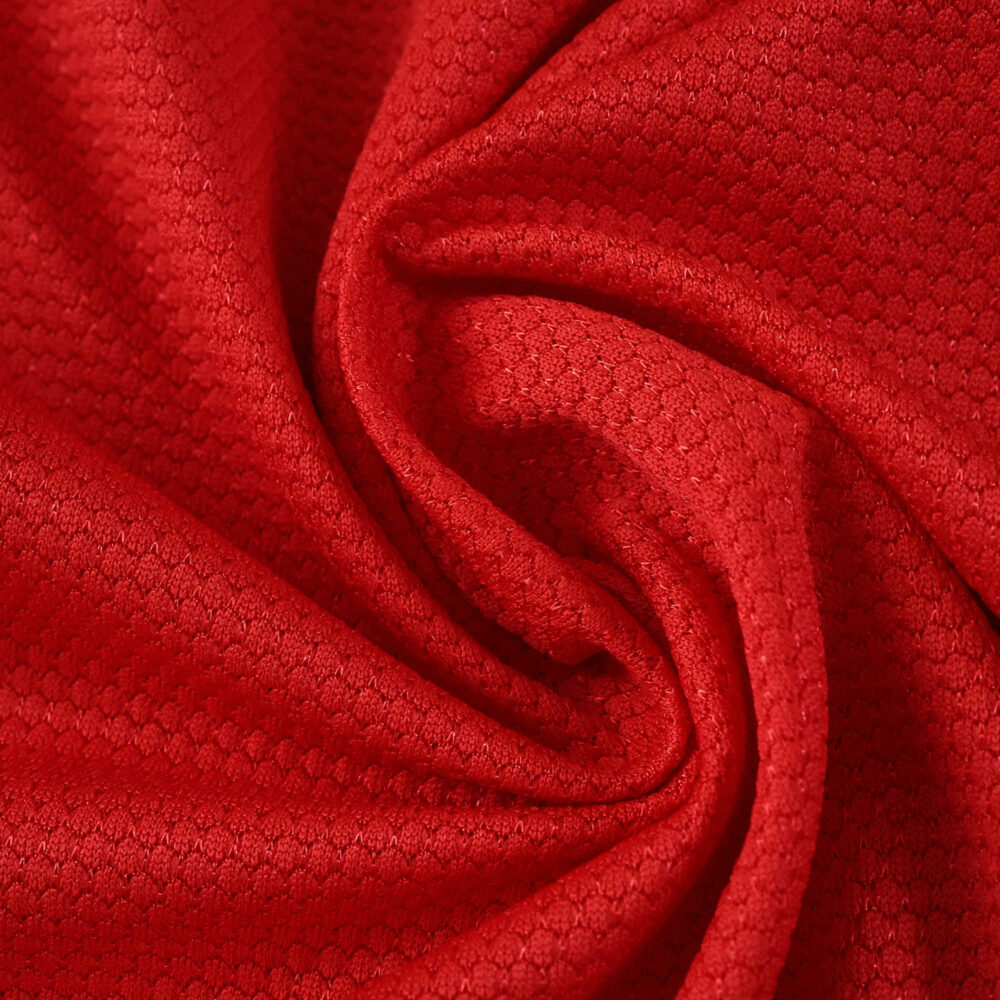 Close-up of the red textured fabric used for the SL Benfica 2025/26 Home Fan Version jersey.